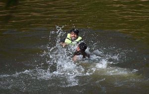 People cool off in the stream at Angoori Dam to escape the sweltering heat in the federal capital