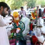 A vendor selling Ice gola at his cart in the city