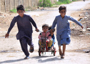 Children enjoy riding bicycle toys at Latifabad