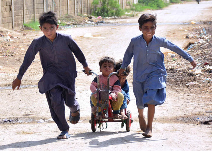 Children enjoy riding bicycle toys at Latifabad