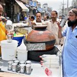 A vendor sells the traditional drink lassi at Muslim market