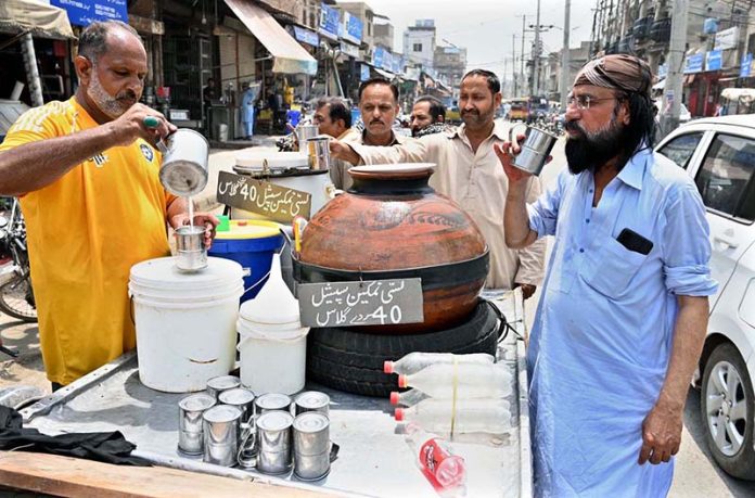 A vendor sells the traditional drink lassi at Muslim market