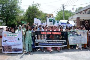 Students of Government College Women University Faisalabad (GCWUF) hold placards and banners to express gratitude to the Pakistan Army for its successful response against Indian aggression