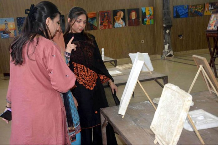 Visitors take keen interest in the three painting exhibitions organized by male and female students of the University of Education, Lower Mall Campus in provincial capital
