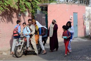 Schoolchildren arrive at their school as educational institutions resume after a three-day closure due to Indian aggression