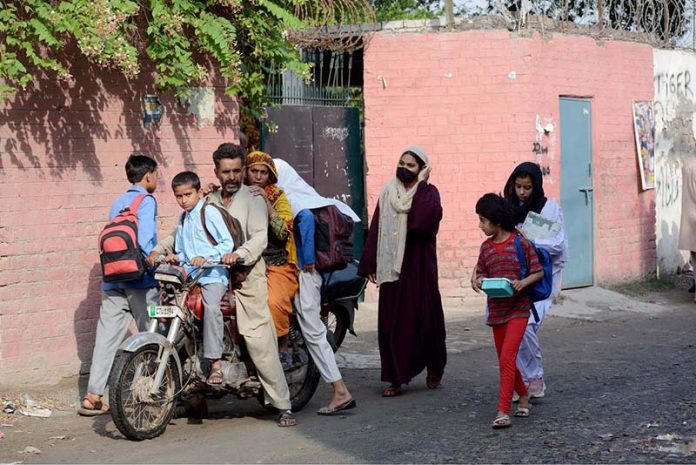 Schoolchildren arrive at their school as educational institutions resume after a three-day closure due to Indian aggression