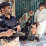 Health worker administering polio vaccine to a child during a polio campaign in the Provincial Capital