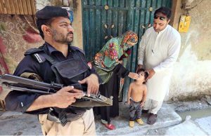 Health worker administering polio vaccine to a child during a polio campaign in the Provincial Capital