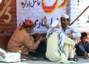 A barber busy in cutting hair of a customer at his roadside setup as the world celebrates International Labour Day. May 1st, International Workers' Day, commemorates the historic struggles of working people worldwide. In 1884, the Federation of Organized Trades and Labour Unions passed a resolution declaring that eight hours would constitute a legal day's work, effective from May 1, 1886