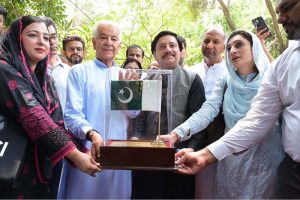Defense Minister Khawaja Muhammad Asif presents a shield to the school principal during a ceremony held to express gratitude to a private school for honoring the Pakistani army's brilliant victory in the war against India.