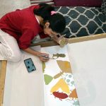 A student engages in painting and drawing activities during an art class at Alhamra Arts Council