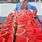 A vendor displaying watermelons to attract the customers at his roadside setup