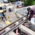 A youngster crossing the Railway Bridge near Municipal Higher Secondary School