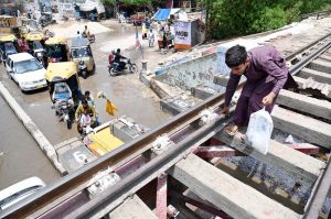 A youngster crossing the Railway Bridge near Municipal Higher Secondary School