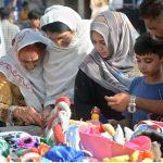 Women purchasing used toys for their kids at Empress Market