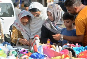 Women purchasing used toys for their kids at Empress Market