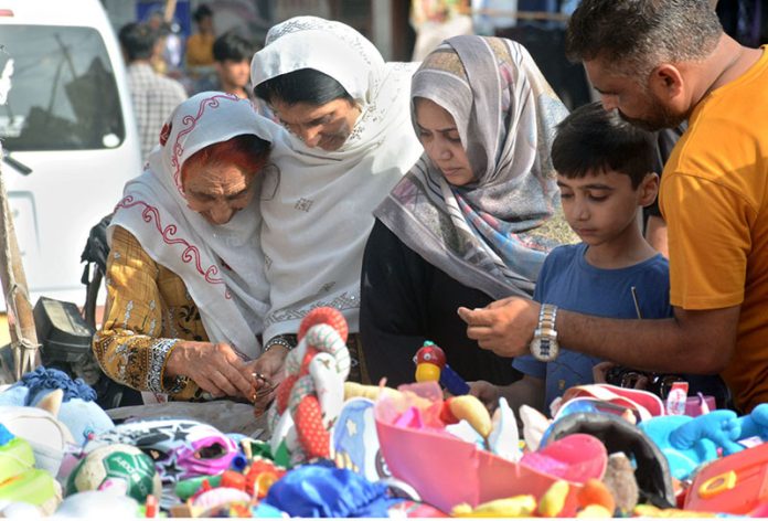 Women purchasing used toys for their kids at Empress Market