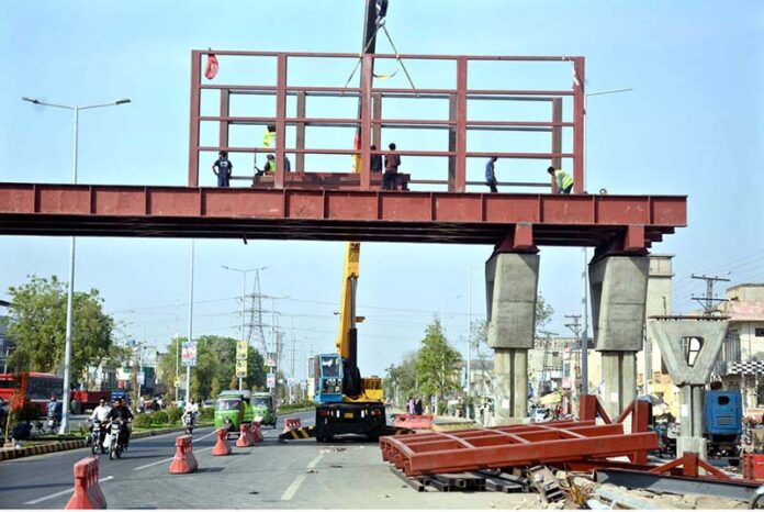 Labourers are busy installing overhead bridge as the world celebrates International Labour Day. May 1st, International Workers' Day, commemorates the historic struggles of working people worldwide. In 1884, the Federation of Organized Trades and Labour Unions passed a resolution declaring that eight hours would constitute a legal day's work, effective from May 1, 1886