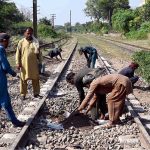 Railway workers busy repairing a track near Shahdara Railway Station to ensure safe and smooth train operations in the provincial capital