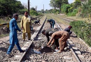 : Railway workers busy repairing a track near Shahdara Railway Station to ensure safe and smooth train operations in the provincial capital
