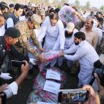 Federal Minister for Defence Production, Barrister Raza Hayat Harraj lays a floral wreath on the grave of the martyred soldiers in Khanewal