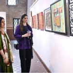 Visitor girls observe and admire a masterpiece of art on display at the NCA Art Gallery, Anarkali