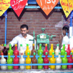 A vendor busy in selling Ice Gola to children at Foot Street Golmandi