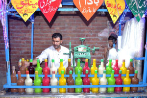 A vendor busy in selling Ice Gola to children at Foot Street Golmandi