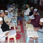 People are reciting verses of the Holy Quran during a Quran Khawani sitting organized in a local Masjid to celebrate Youm-e-Tashakur