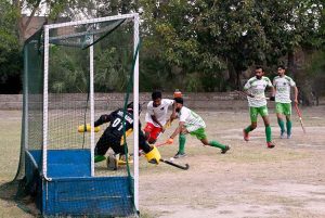 A goalkeeper in full action during a friendly hockey match between Ali Amir Hockey Club and Mujahid Zafar Hockey Academy