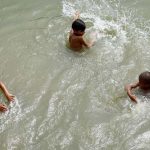 Youngsters bathing in Rice Canal to get relief from sizzling hot weather in the city