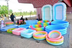 A vendor displaying the water pools to attract the customers for selling under the fly over at Qasimabad
