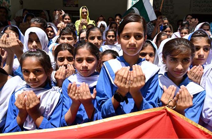 Teachers and Students of Government Girls High School Little Folks offering Dua during a ceremony to mark Youm-e-Tashakur (Thanksgiving Day) to expressing solidarity with the Pakistan Armed Forces following the successful military operation ‘Bunyan-um- Marsous’ against Indian aggressions