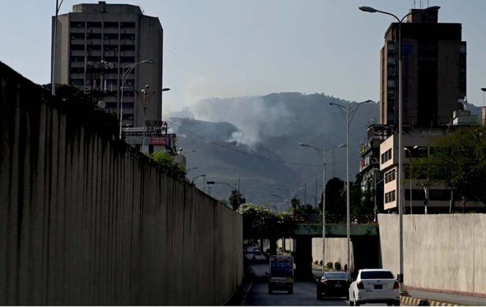 A view of smoke emitting after fire erupts at Margalla Hills in the Federal Capital