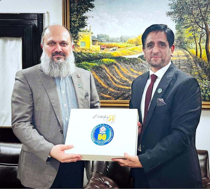 FCCI President Rehan Naseem Bharara presents a Silver Jubilee souvenir to Federal Minister for Commerce Jam Kamal Khan on behalf of the Faisalabad Chamber