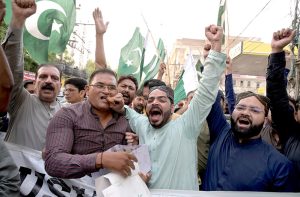 People distributing sweets on the success of Operation Bunyan-un-Marsus against Indian aggression in a rally at Hyder Chowk.