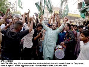 People distributing sweets on the success of Operation Bunyan-un-Marsus against Indian aggression in a rally at Hyder Chowk.