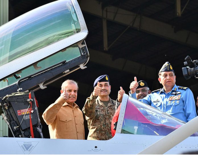 Prime Minister Muhammad Shehbaz Sharif celebrates Pakistan's victory in Maarka-e-Haq, with the officers of Pakistan Air Force at the Kamra Aeronautical Complex