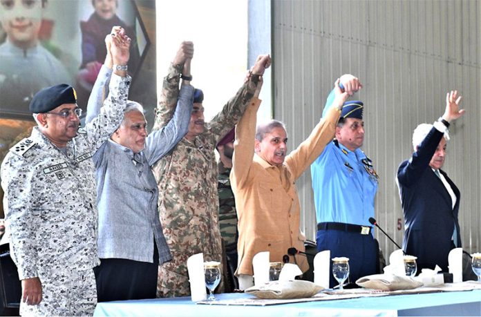Prime Minister Muhammad Shehbaz Sharif celebrates Pakistan's victory in Maarka-e-Haq, with the officers of Pakistan Air Force at the Kamra Aeronautical Complex