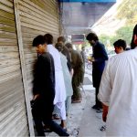 A Lahore Health Department drug inspector seals a medical store near Ganga Ram Hospital as part of a crackdown on counterfeit medicines