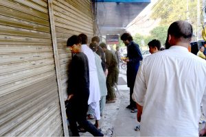 A Lahore Health Department drug inspector seals a medical store near Ganga Ram Hospital as part of a crackdown on counterfeit medicines