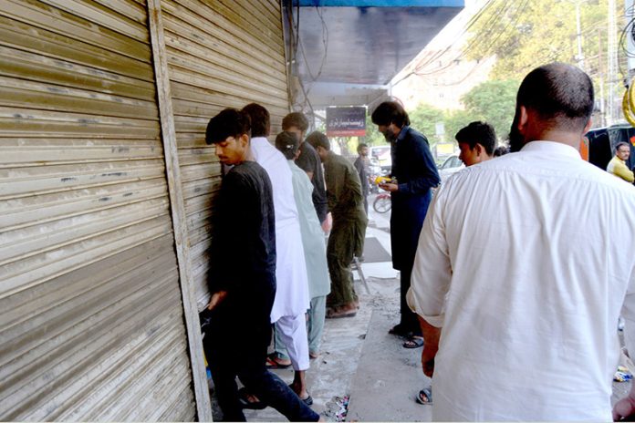 A Lahore Health Department drug inspector seals a medical store near Ganga Ram Hospital as part of a crackdown on counterfeit medicines