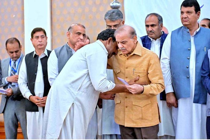 Prime Minister Muhammad Shehbaz Sharif distributing relief cheques amongst the families of martyred during Ma’arka-e-Haq