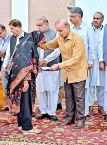 Prime Minister Muhammad Shehbaz Sharif distributing relief cheques amongst the families of martyred during Ma’arka-e-Haq
