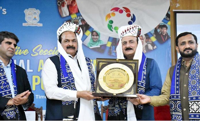 Chairman Prime Minister Youth Program Rana Mashhood Ahmed Khan being presented with a commemorative shield by Ghazi University Vice Chancellor Dr. Ashfaq Ahmed