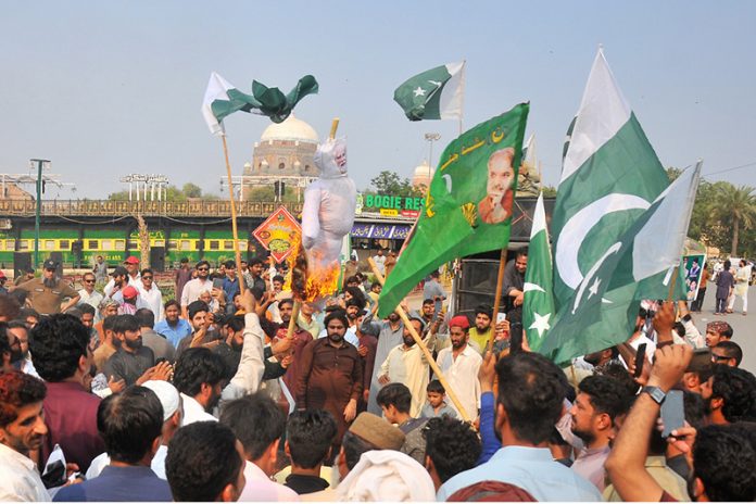 Protesters burn an effigy of Indian Prime Minister Narendra Modi during a protest after India launched missile strikes in Pakistan