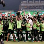 Lahore Qalandars players pose for a group photo as their captain, Shaheen Shah Afridi, lifts the trophy after winning the PSL-X T20 Final against Quetta Gladiators at Gaddafi Stadium..