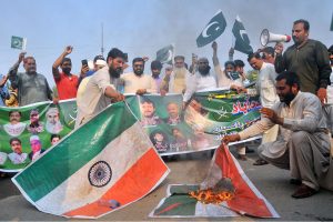 Protesters burn an effigy of Indian Prime Minister Narendra Modi during a protest after India launched missile strikes in Pakistan