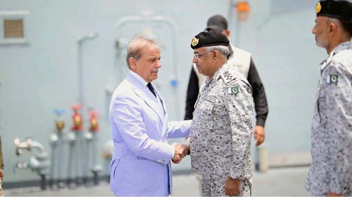 Prime Minister Muhammad Shehbaz Sharif being received by Naval Chief Admiral Naveed Ashraf upon his arrival at Naval Dockyard
