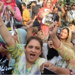 Women activists of various political parties shout slogan in a protest rally in support of Armed Forces at Karachi Press Club